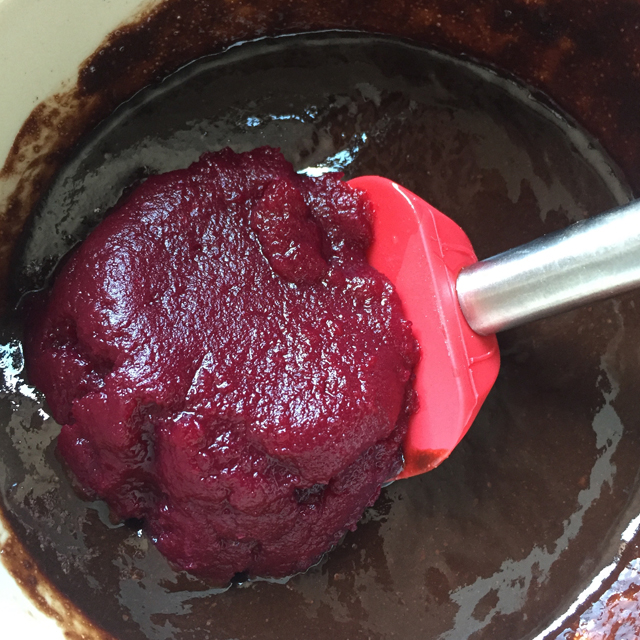 Cooked beets being stirred into other ingredients.
