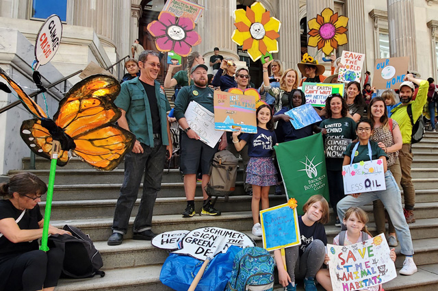 BBG staff and their families with signs at the Global Climate Strike.