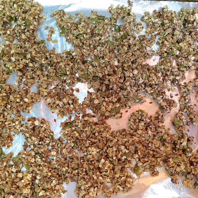 baked granola on a cookie sheet