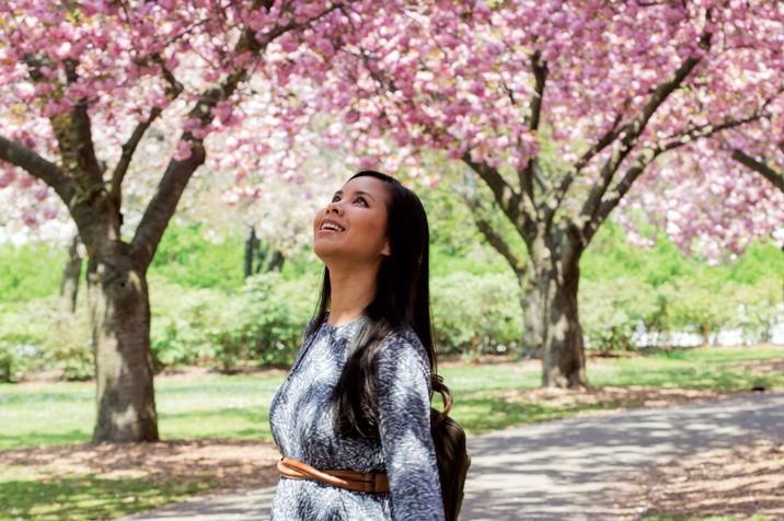 woman amid cherry blossoms